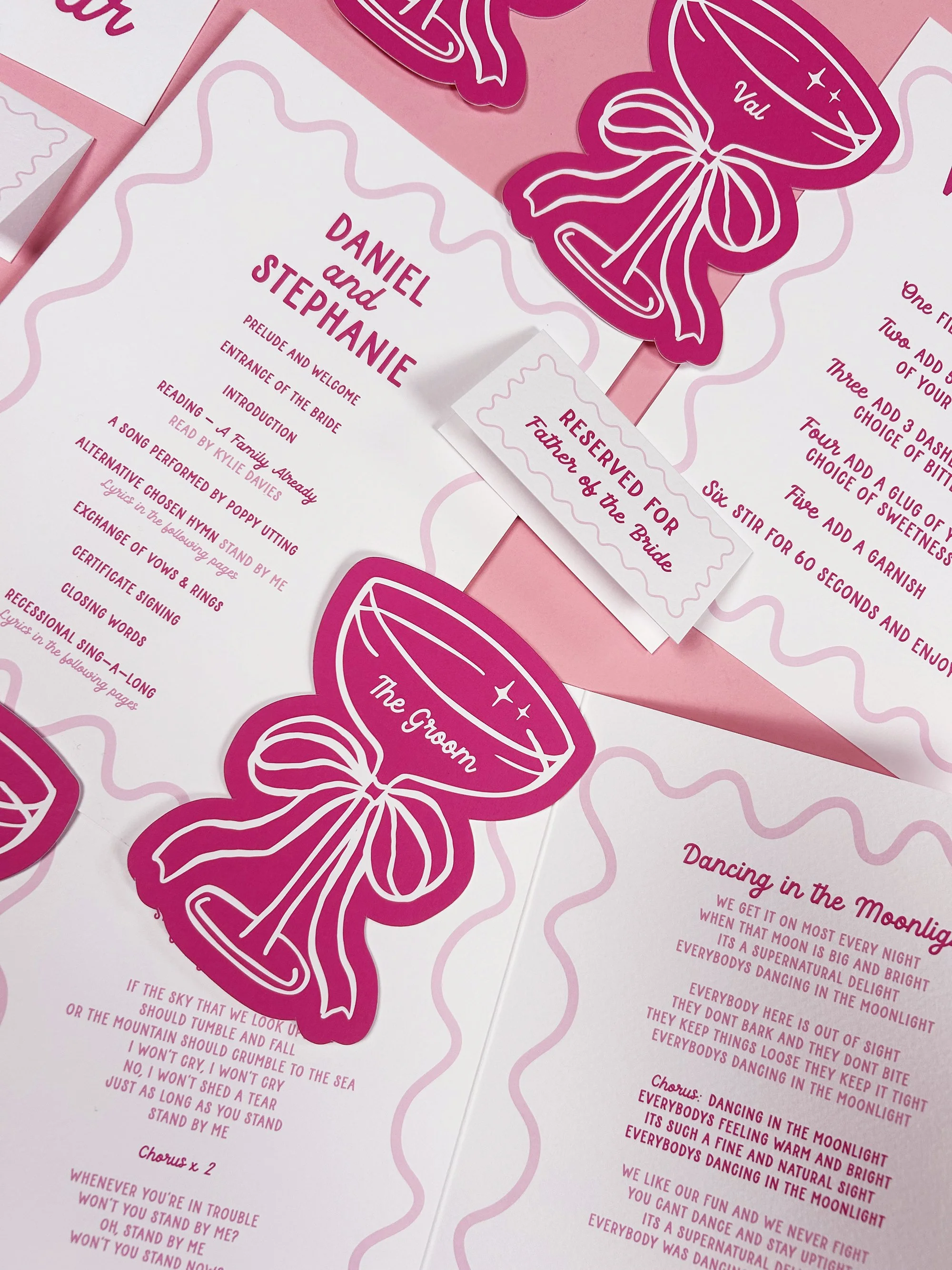 Champagne glass shaped place cards with orders of service and reserved seating signs.