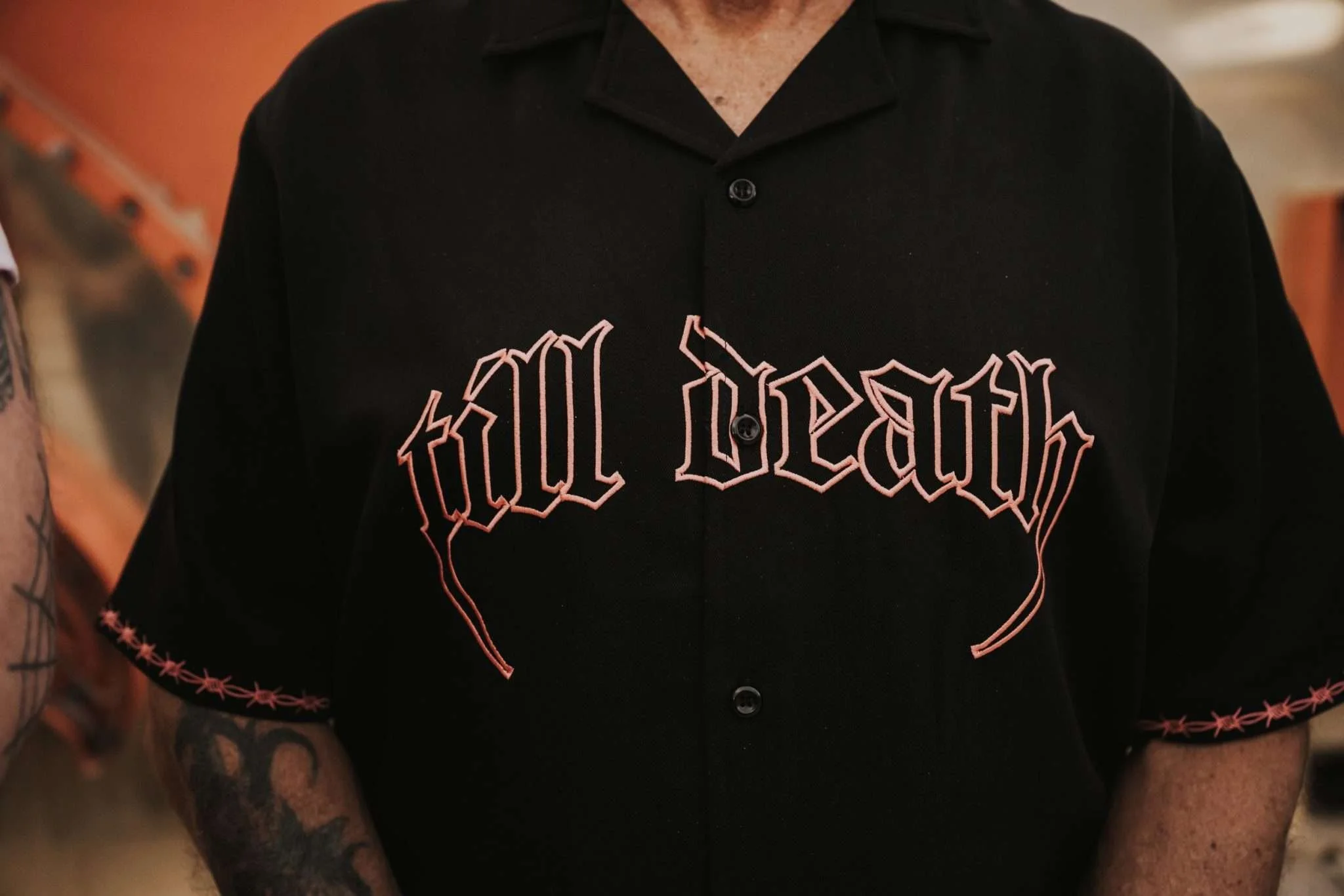 A close crop of a black shirt with graphic writing embodied on it, which says, 'Till Death".