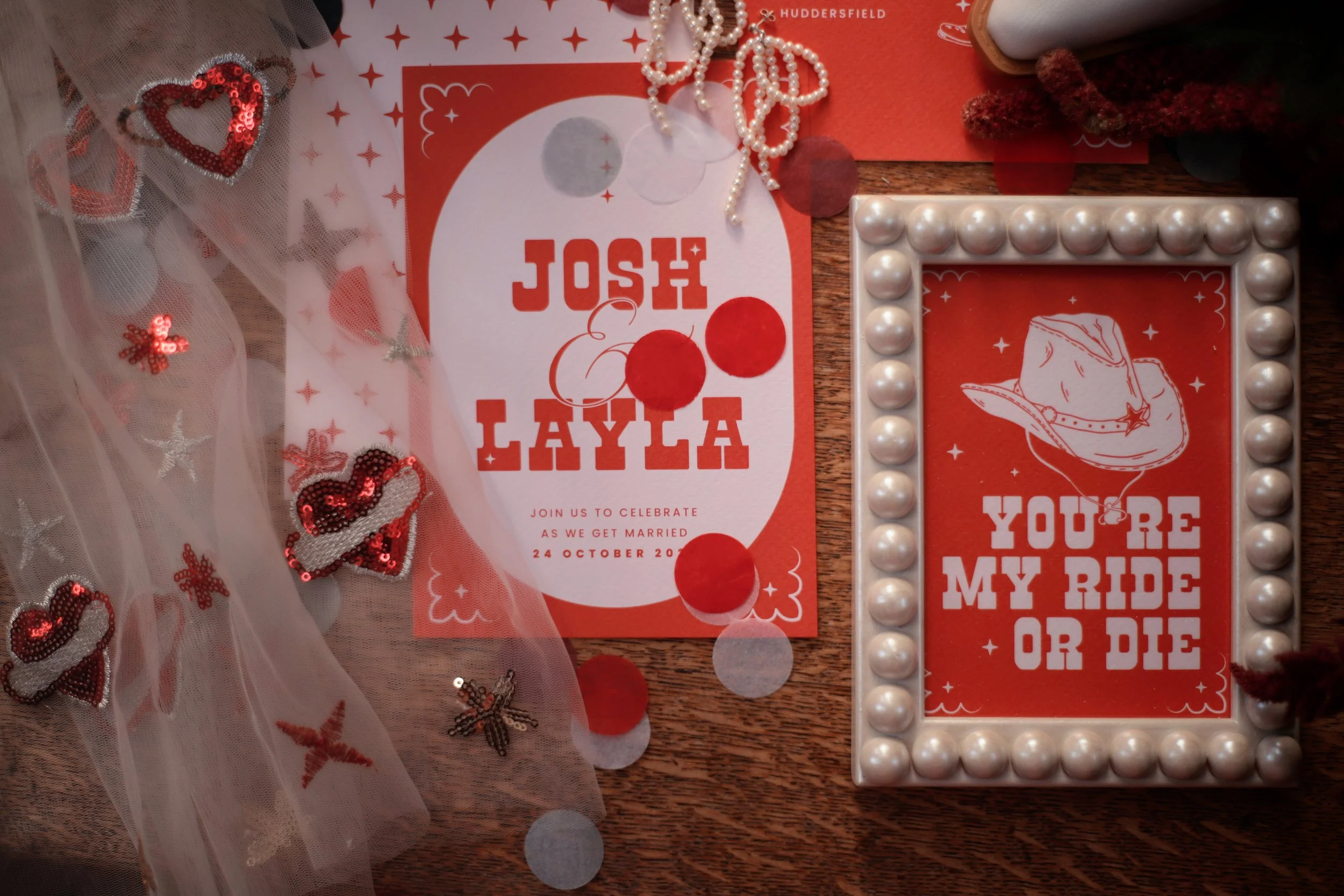 Cowboy-inspired invitations and framed prints in red and white.