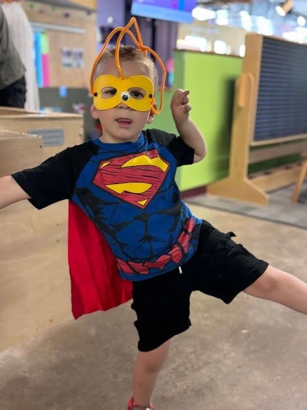Boy showcasing his mask that he created in the Maker Space