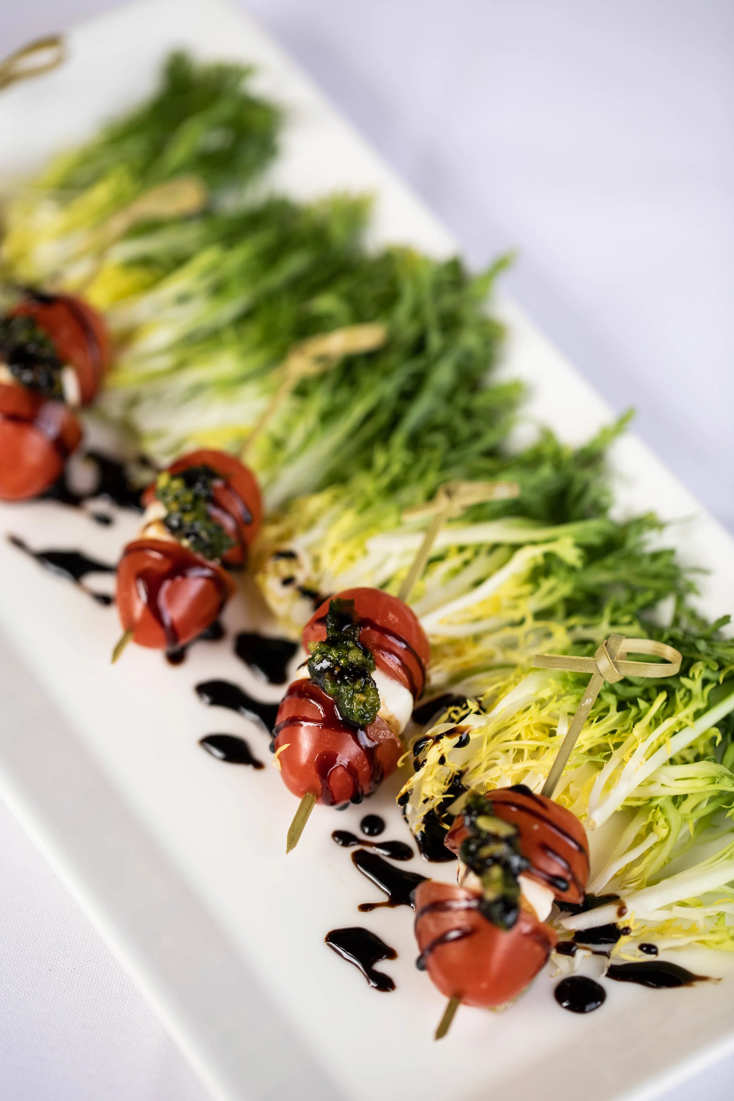 CAPRESE BITES - cherry tomato, fresh mozzarella, balsamic reduction, pesto