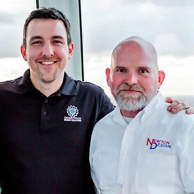 Quantified Design Solutions President David Jones stands with Newton Design President Jeff Newton