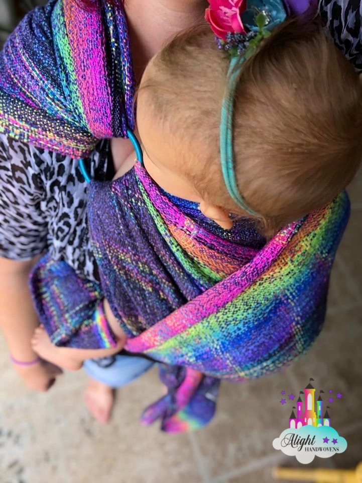 Image of mama and babe shown wearing Nebula Nightfall in a Robins Hip Carry Finished with a Ring.