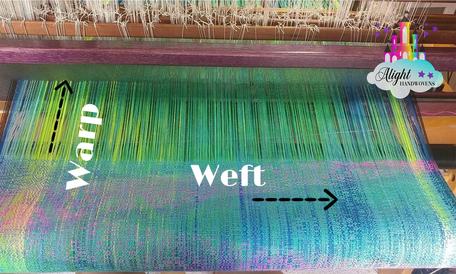 Loom shot of beautiful emerald green warp with hot pink weft threads. The warp and weft are labeled.