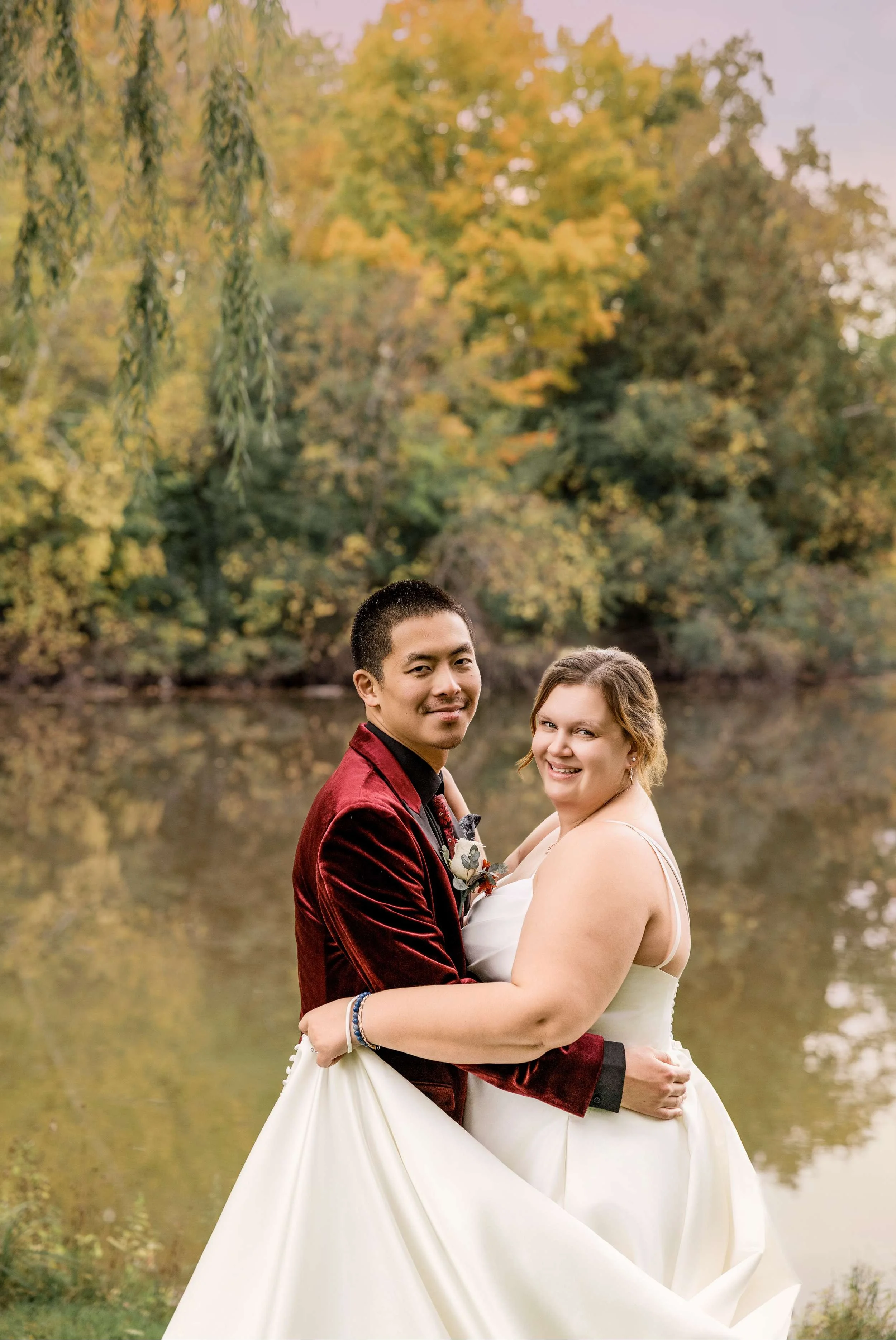 Bride and Groom Portraits by the Water in Autumn Wisconsin