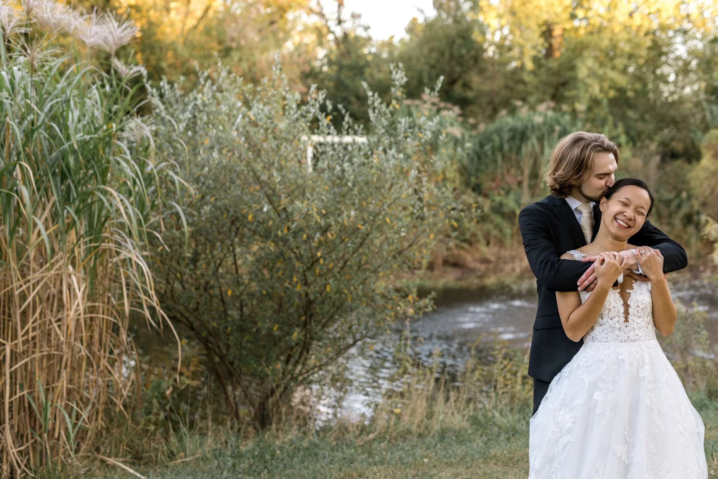 Bride and Groom Dancing Along Water Feature