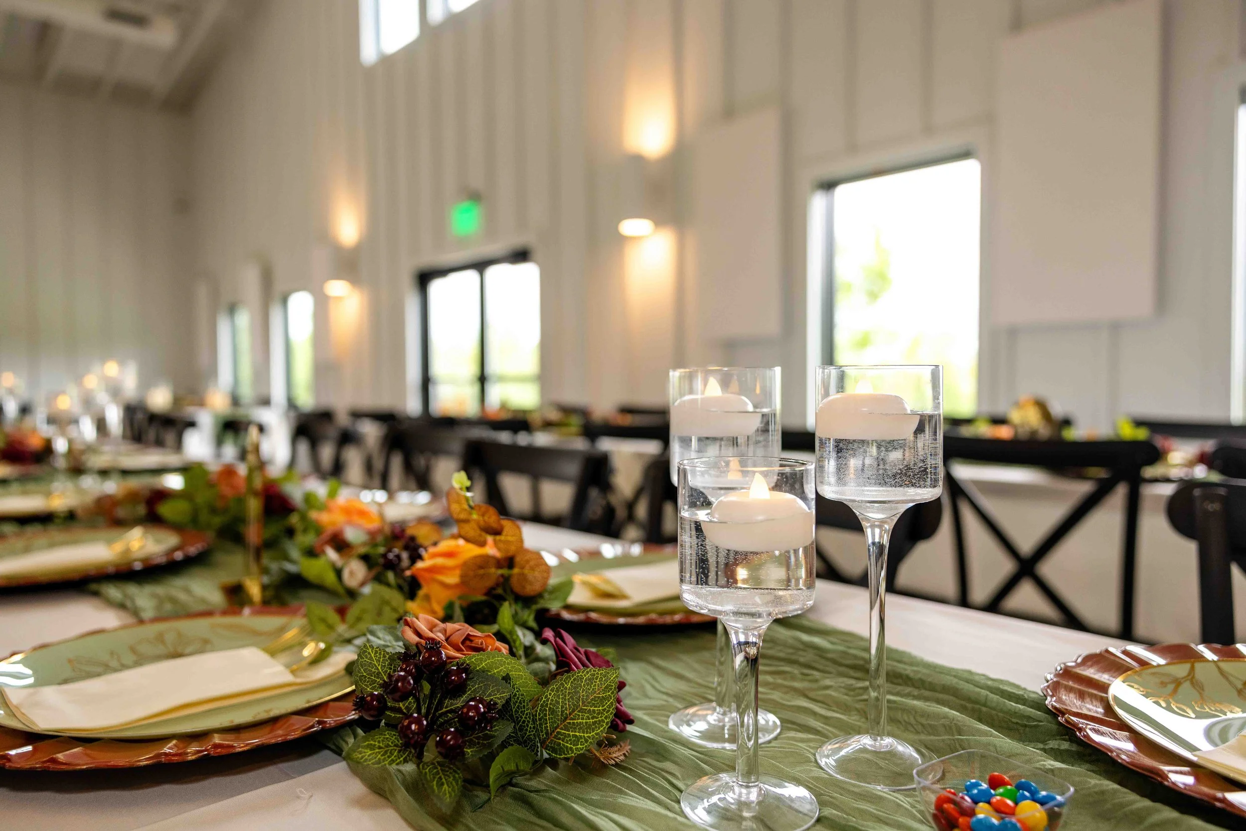 Reception candles creating a romantic atmosphere inside Walnut Ridge Venue in Iowa.