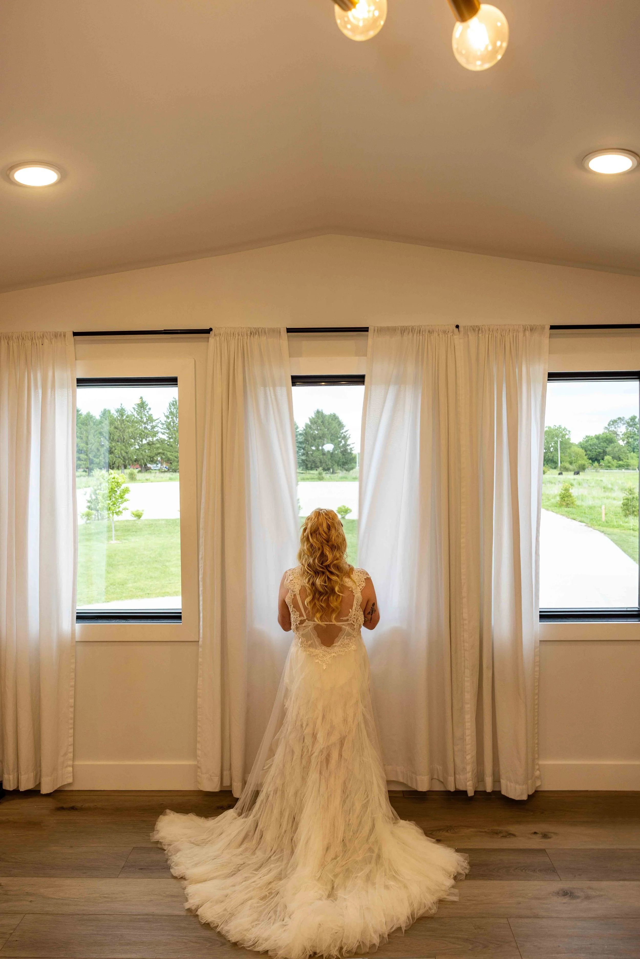 Bride getting ready in the bridal suite at Walnut Ridge Venue before her Iowa wedding ceremony.