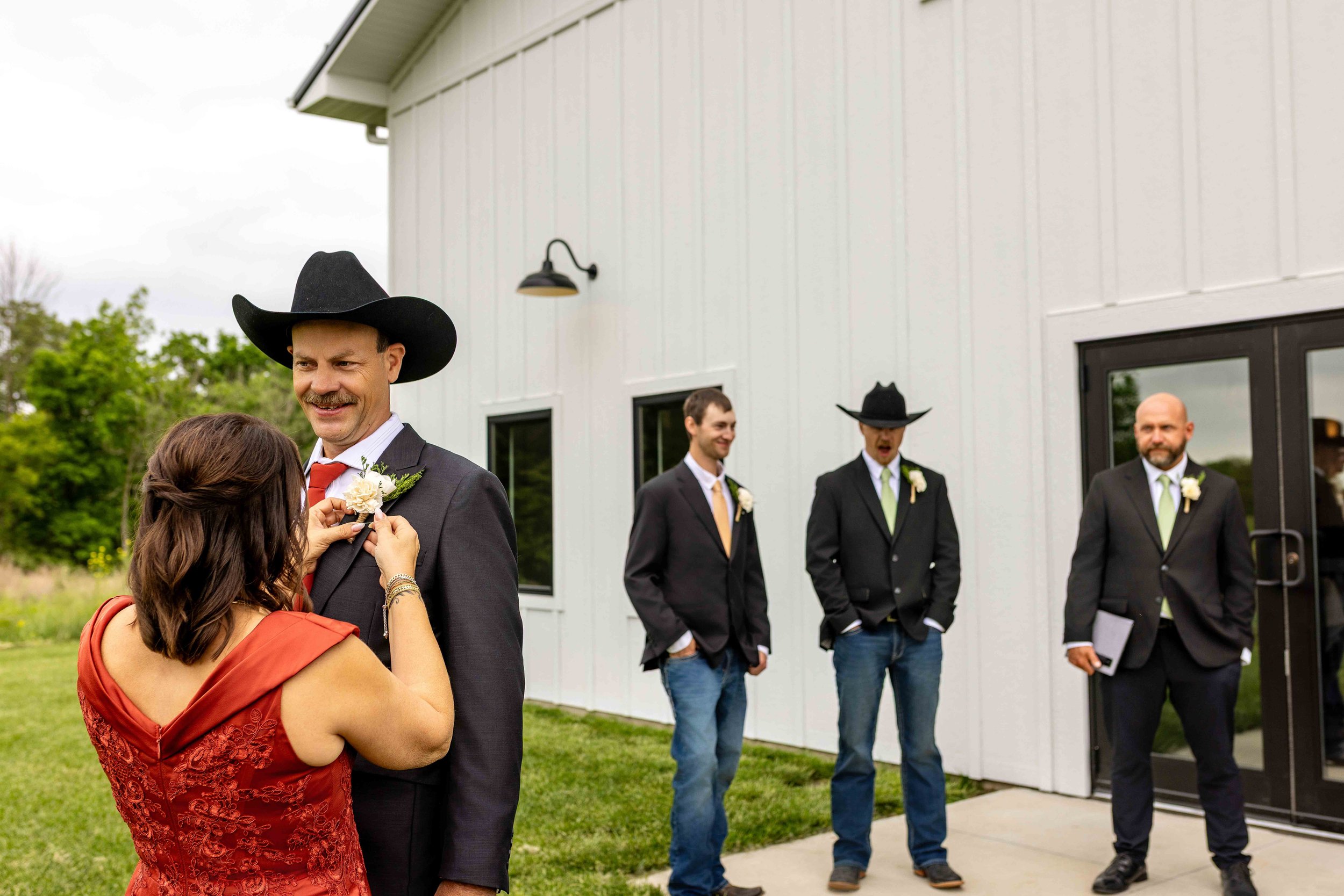Placing the Groom’s Boutonniere at Walnut Ridge Venue