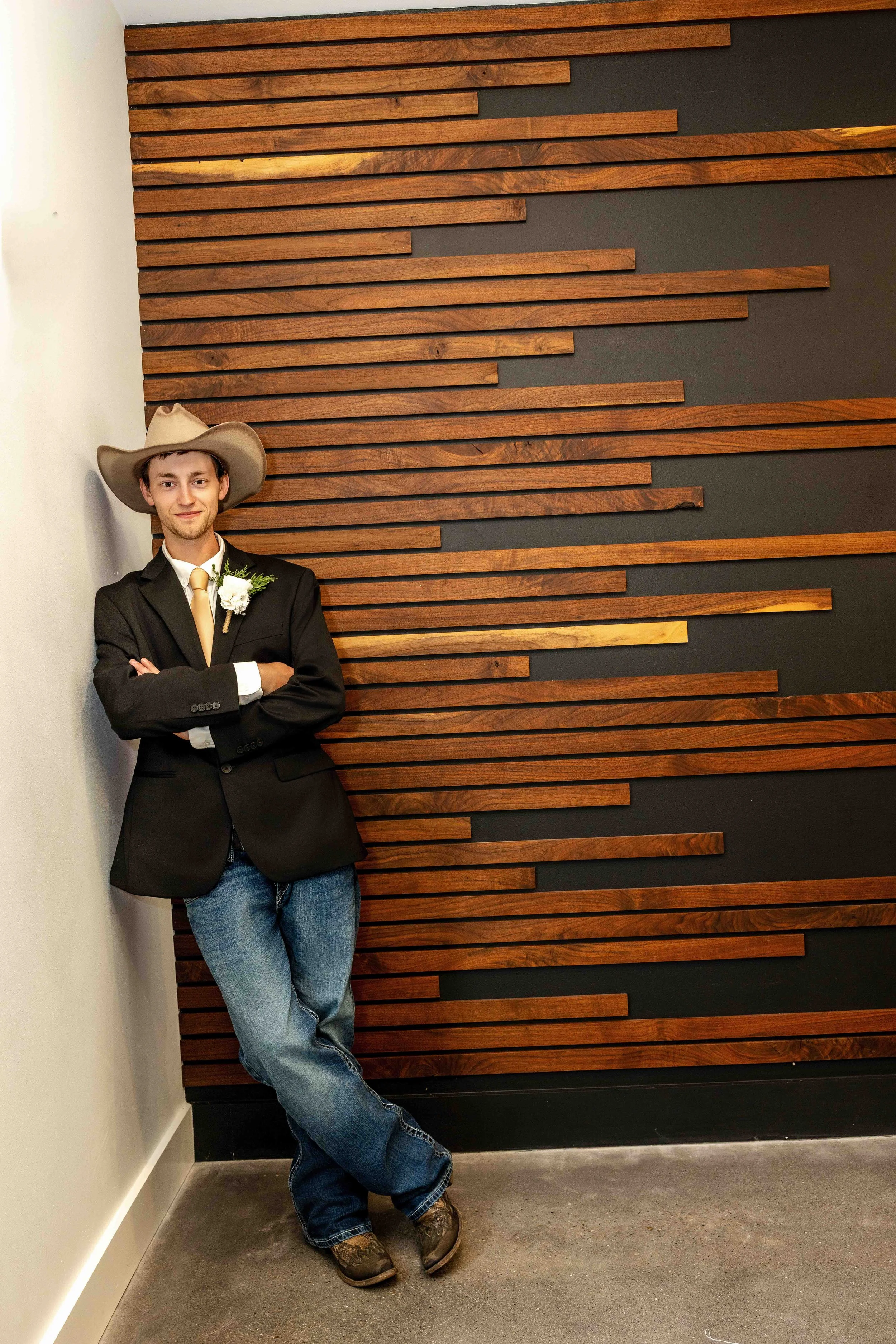 Groom’s cowboy boots and wedding attire photographed inside Walnut Ridge Venue before the ceremony.