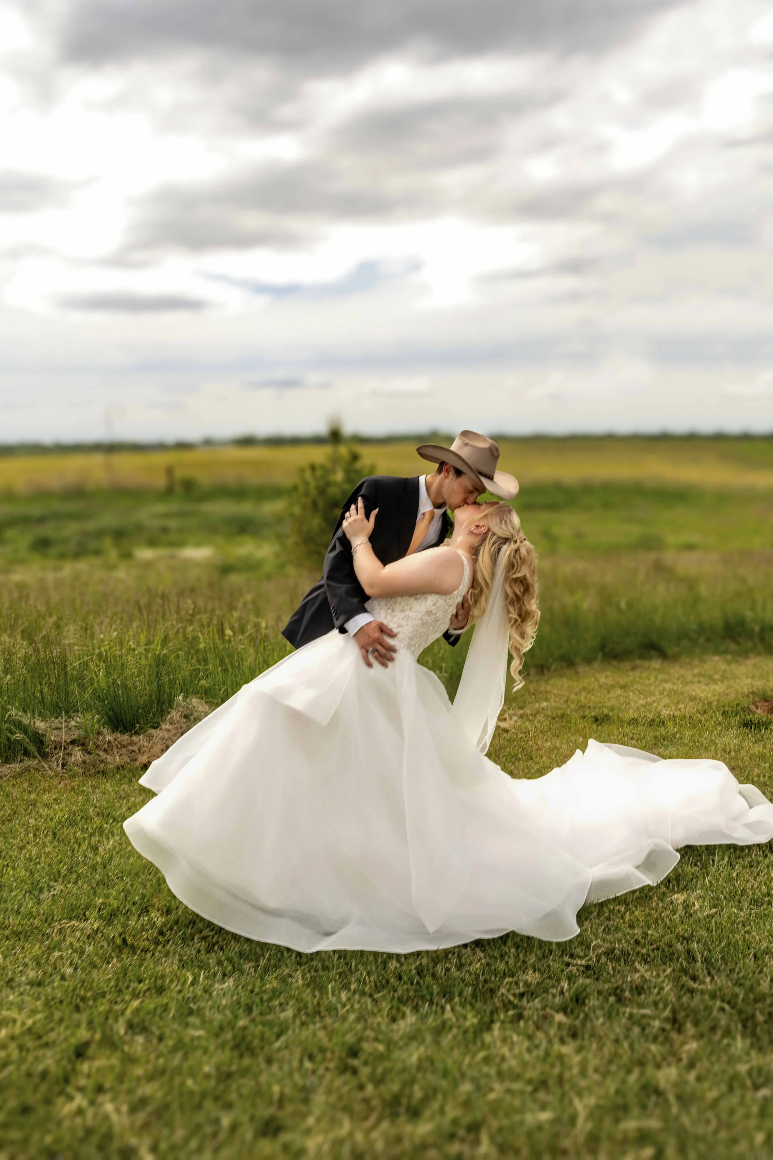 Bride and groom sharing their first kiss as husband and wife during their Walnut Ridge Venue wedding ceremony.