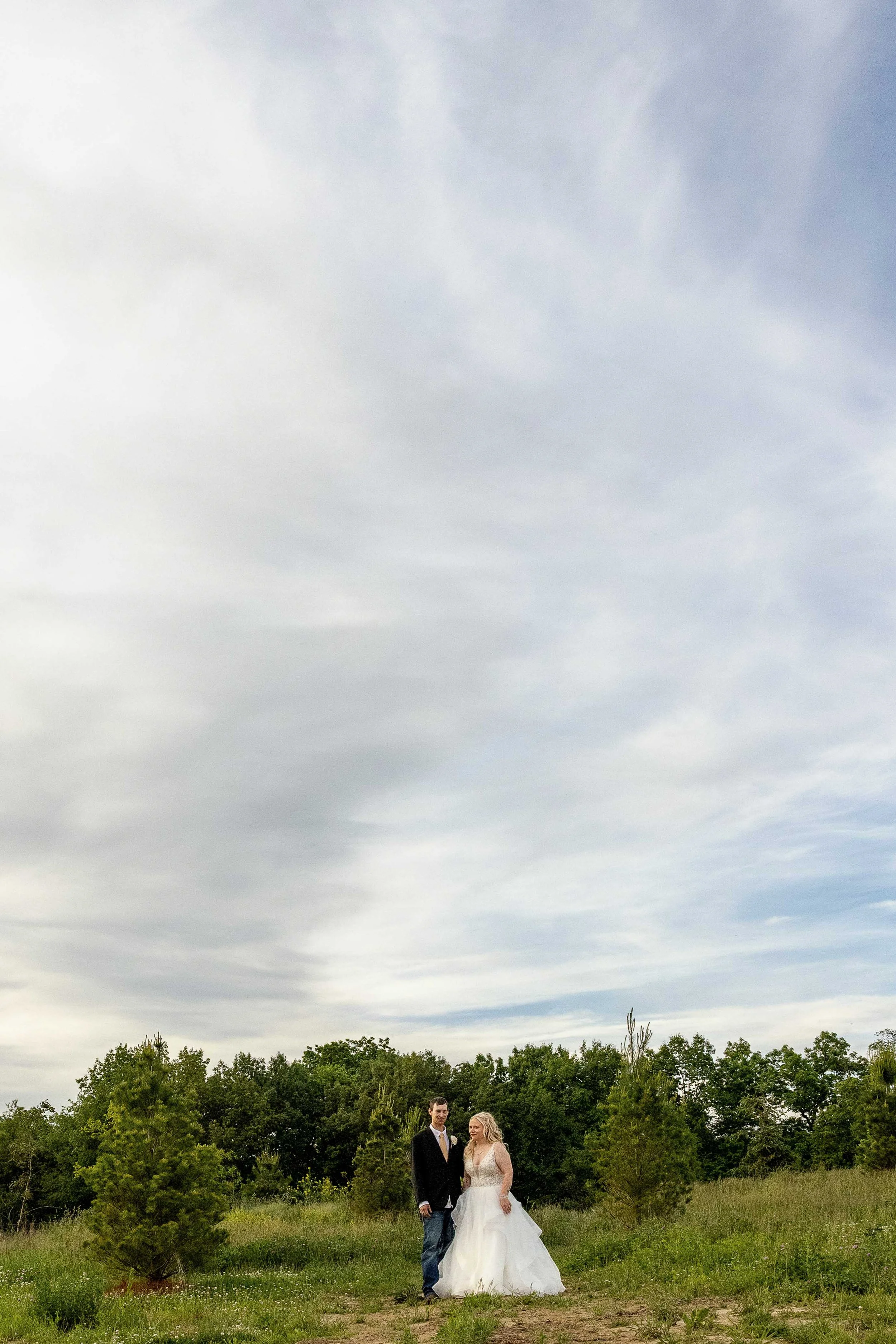 editorial Bride and groom walking together around Walnut Ridge Venue near Cedar Rapids Iowa.
