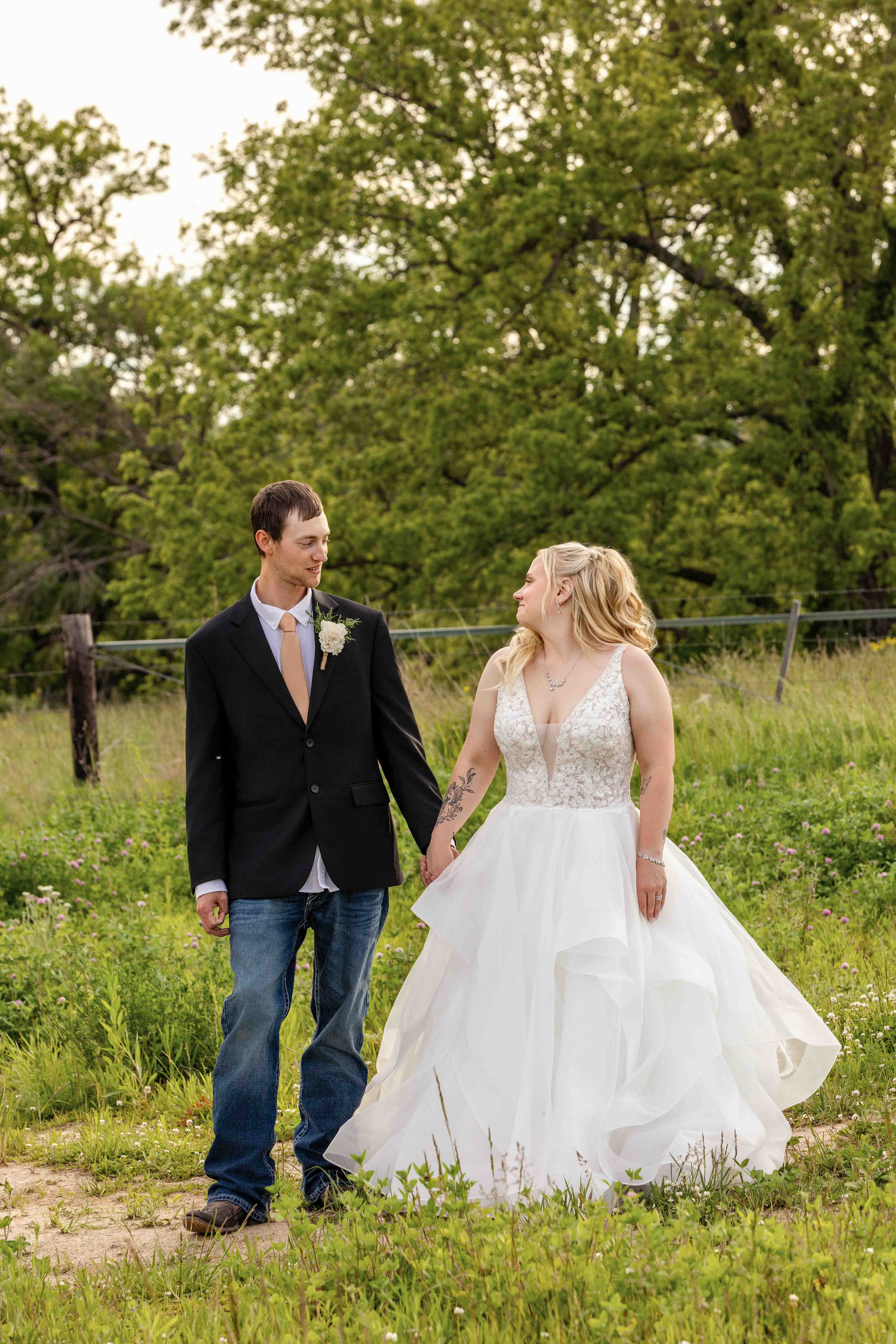 Bride and groom walking together around Walnut Ridge Venue near Cedar Rapids Iowa.