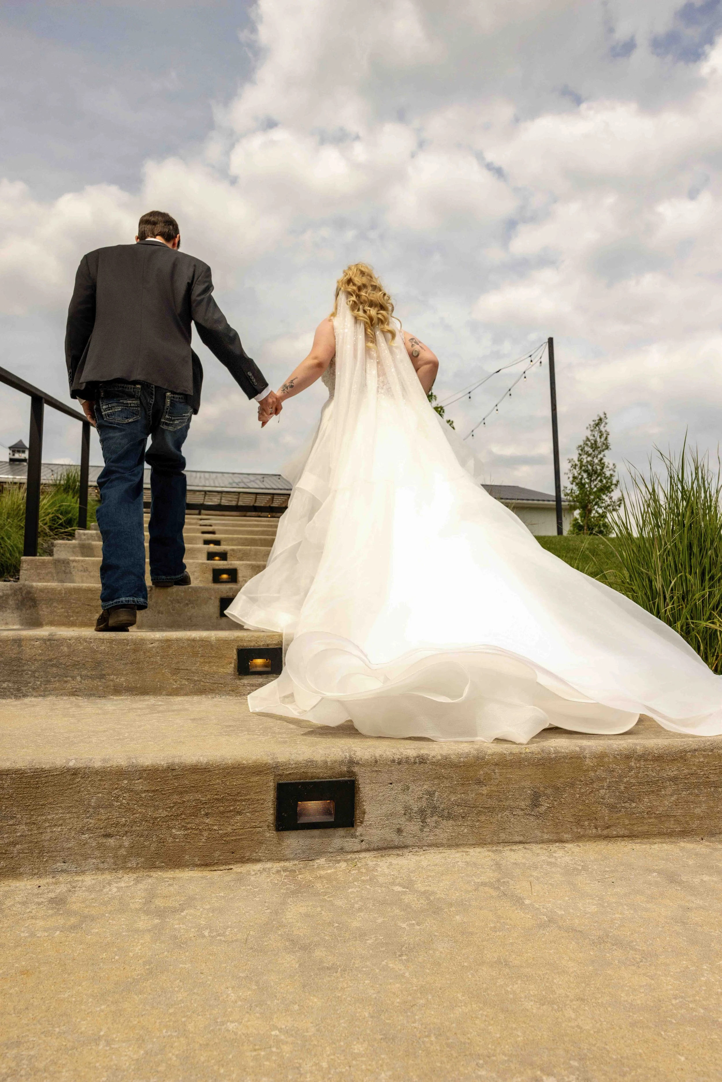 Bride and groom exchanging wedding vows during their ceremony at Walnut Ridge Venue in Iowa.