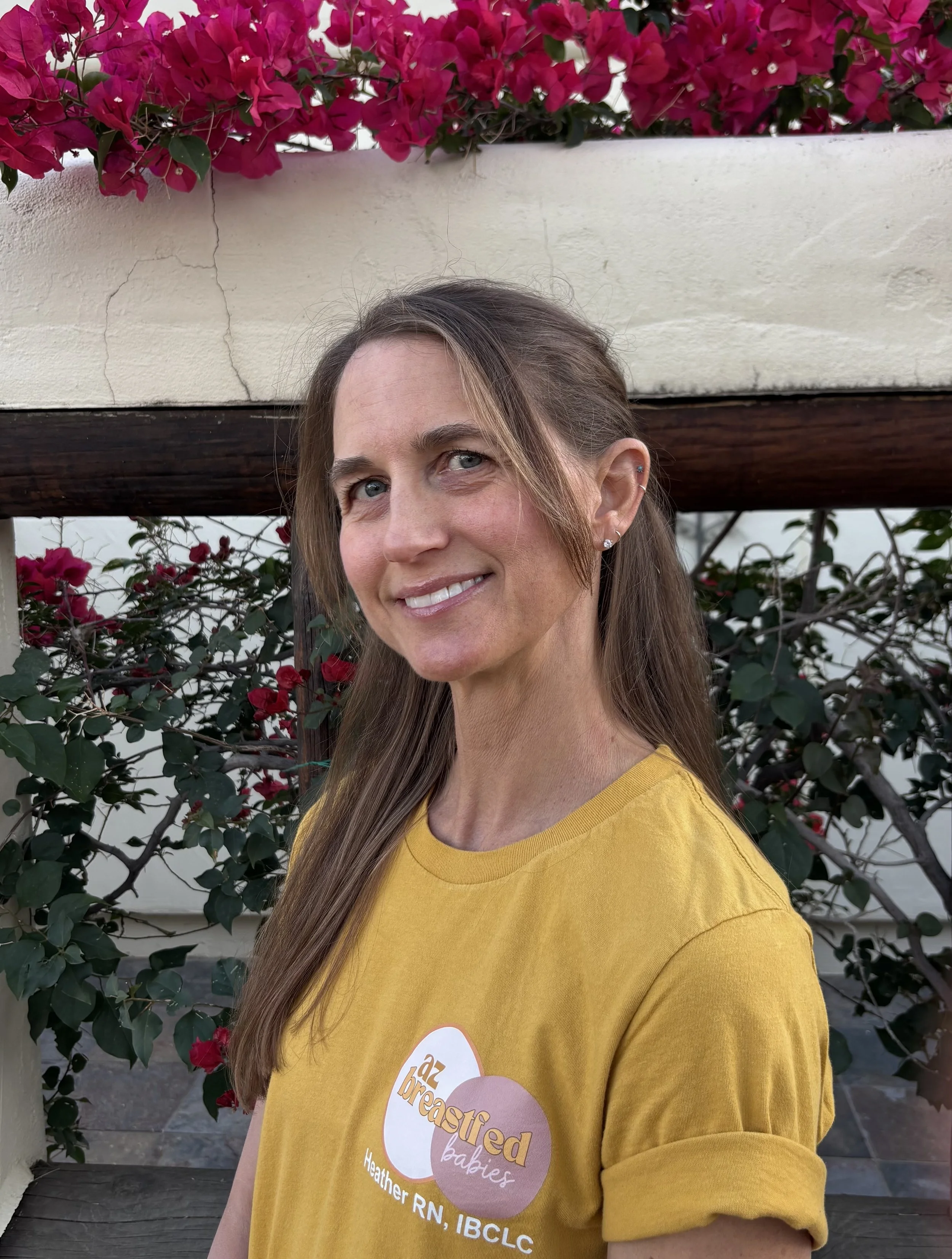 Heather, an internationally board-certified lactation consultant (IBCLC) and registered nurse (RN), providing expert breastfeeding support in an outdoor setting.