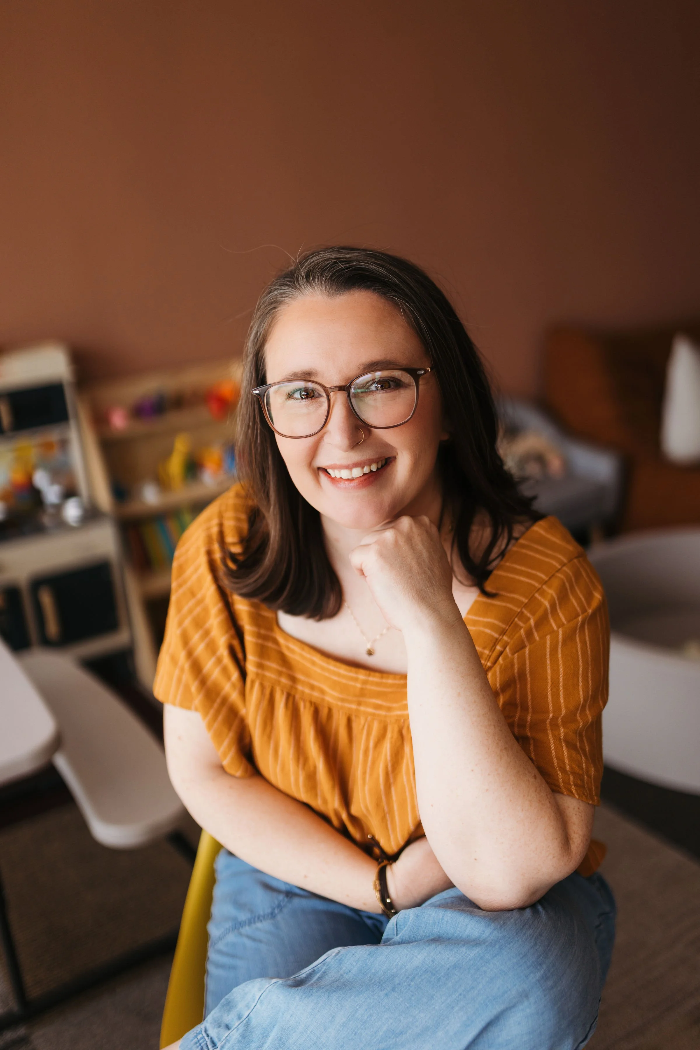 Erin, an internationally board-certified lactation consultant (IBCLC) and registered nurse (RN), supporting families with expert breastfeeding guidance in a beautiful outdoor setting.