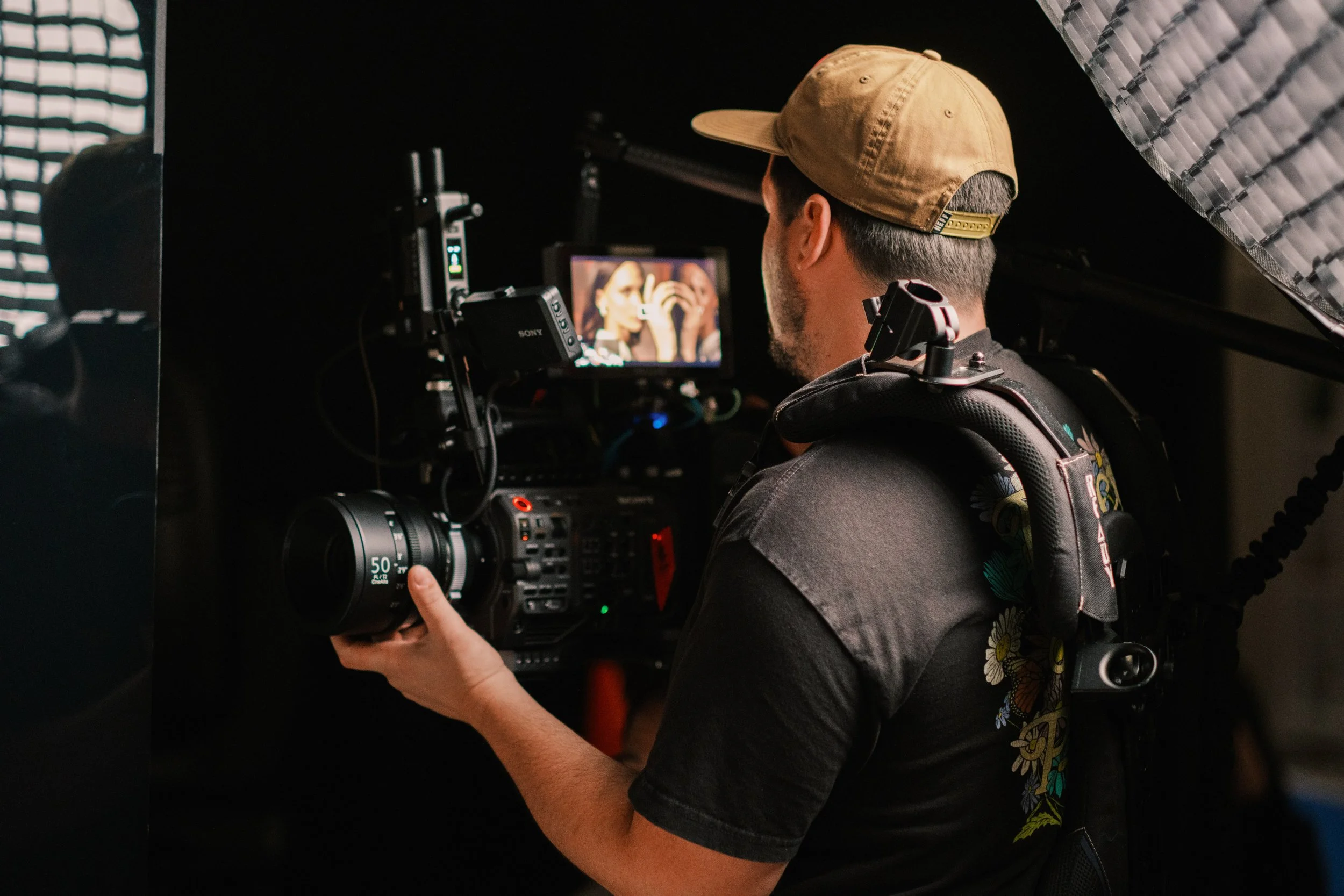 Filip Cerovic, aka Phil Cera, is a Branded entertainment director and showrunner creating scripted/unscripted films and campaigns. A man operating a professional camera on a film or video shoot, looking at a monitor showing a woman with dark hair.