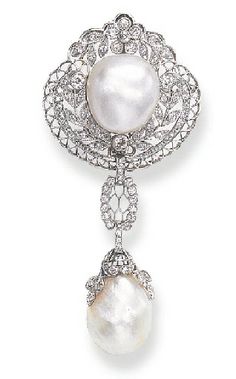 Designed as an openwork rose, single and old mine-cut diamond shield-shaped plaque of foliate motif, set with a baroque pearl, and enhanced by platinum cannetille work, suspending a baroque pearl, with a rose and old mine-cut diamond foliate cap, by similarly-set links, mounted in platinum, circa 1910. Signed B.S.&F. for Black, Starr & Frost