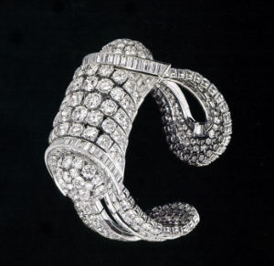 The Cambodian style bracelet, made of platinum, with brilliant cut diamonds and baguettes, made by Frères Rubel workshop in 1938. it has a heavy aspect but conceals a mechanical system and springs in order to be opened and placed on the wrist.