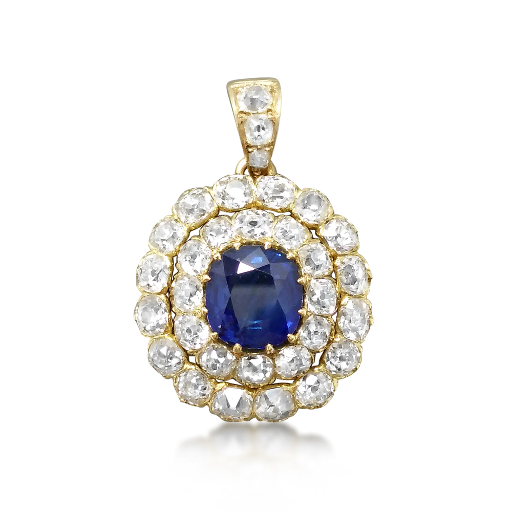 An antique pendant set with a blue sapphire surrounded by Old Mine Cut diamonds, previously sold at Revival Jewels