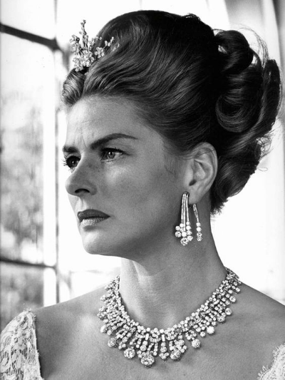 Ingrid Bergman on the set of The Visit in 1964, wearing a Bulgari floral spray brooch in her hair.