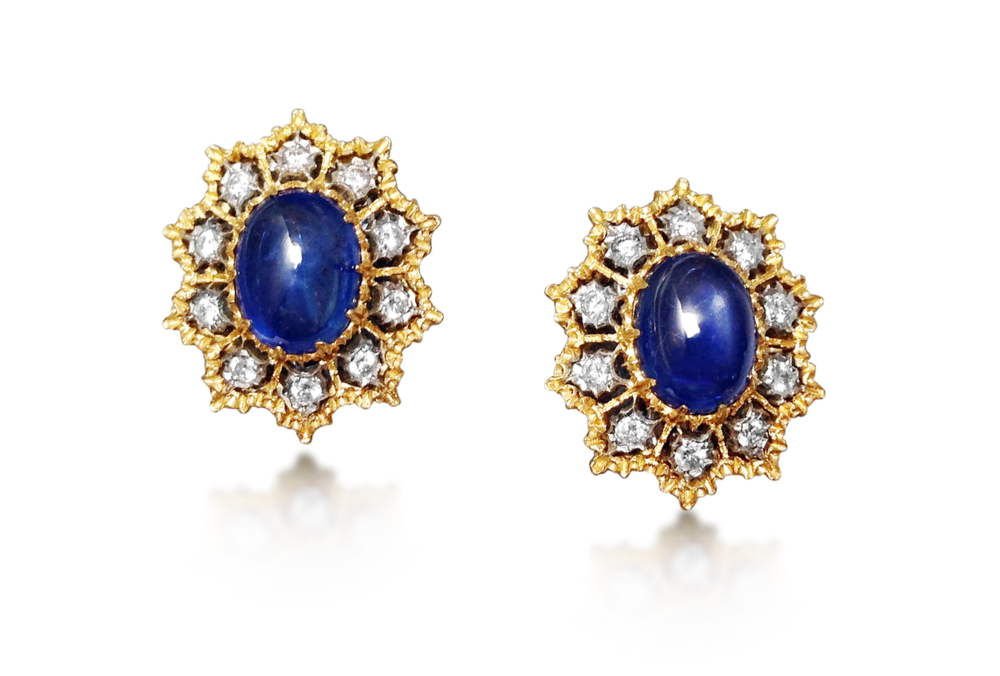 Previously sold at Revival Jewels: A pair of sapphire and diamond earrings. Centrally set with cabochon sapphires approx 8-10 cts in total, the earrings feature lace motif gold open work enhanced by circular-cut diamonds. The pair is mounted in 18K gold, and signed Gianmaria Buccellati, Italy.