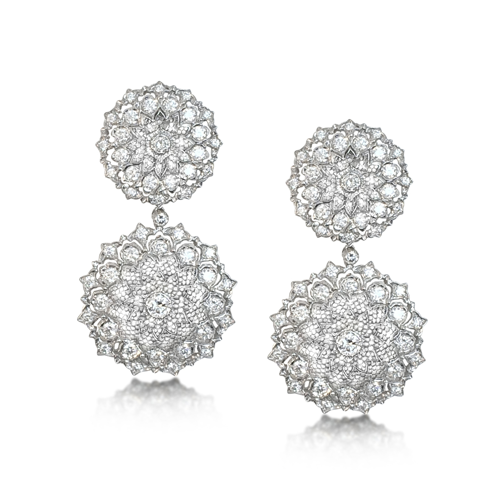 Previously sold at Revival Jewels: A pair of Retro-era diamond and white gold earrings with detachable pendants. Set with 50 diamonds with total weight approximately 12-13 carats.