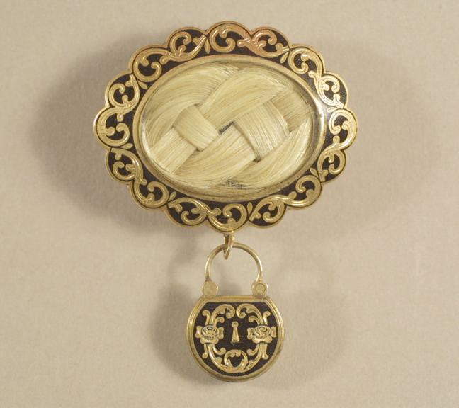 A pendant brooch, with woven hair placed into glass locket, circa 1848.