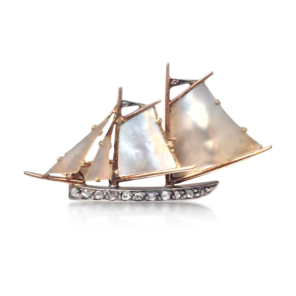 AN ANTIQUE, GOLD, DIAMOND AND MOTHER OF PEARL SAILBOAT BROOCH - SOLD