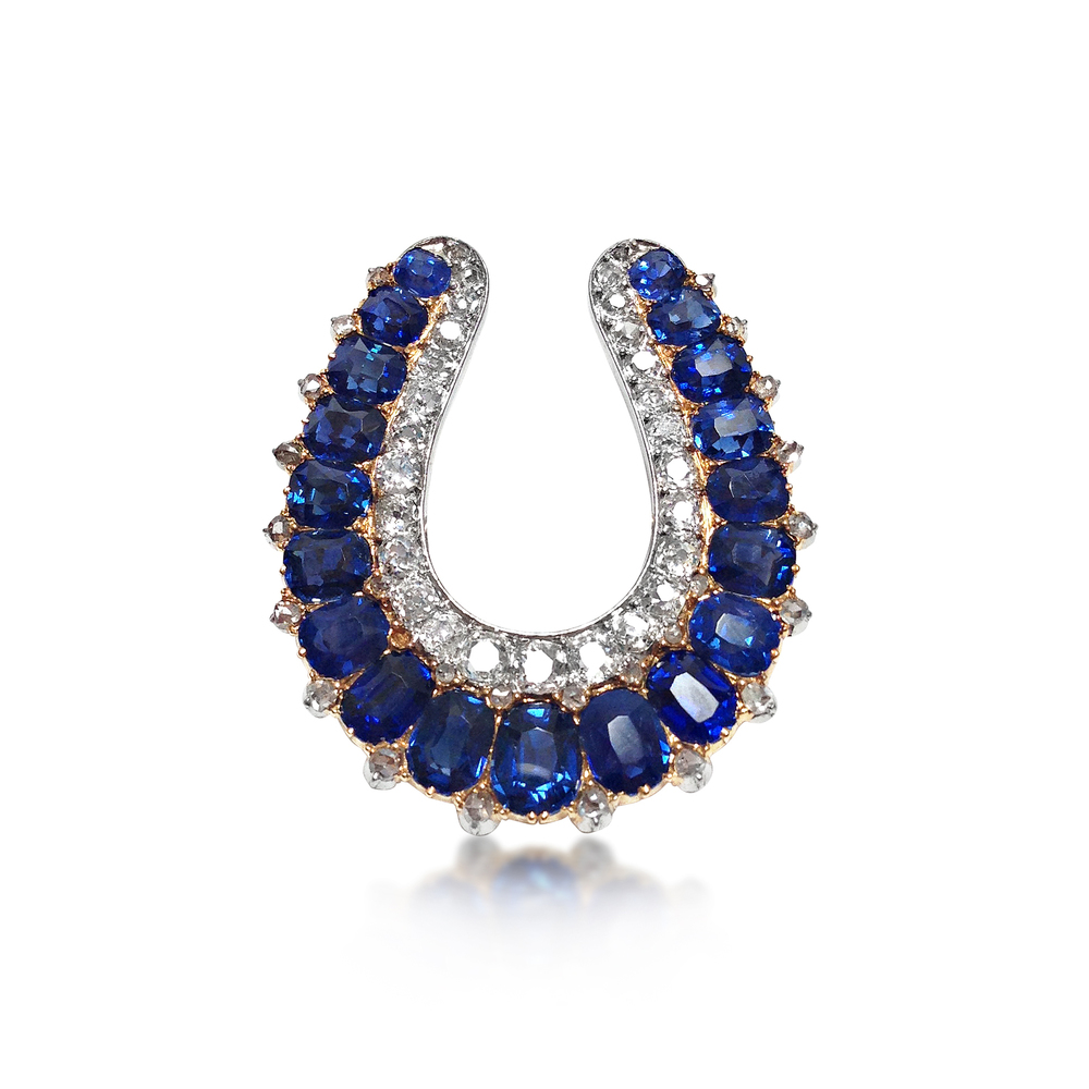 AN ANTIQUE SAPPHIRE AND DIAMOND HORSESHOE PENDANT 
