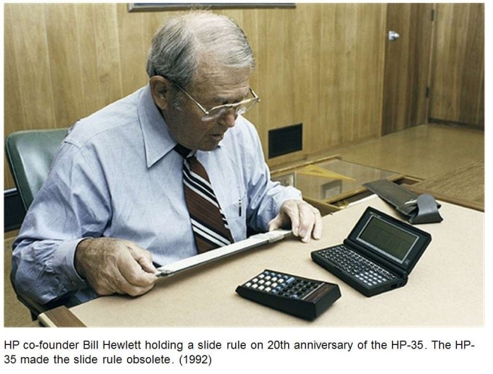 Figure 2, HP co-founder, Bill Hewlett, holding a slide rule on the 20th anniversary of the HP-35. The HP-35 made the slide rule obsolete.