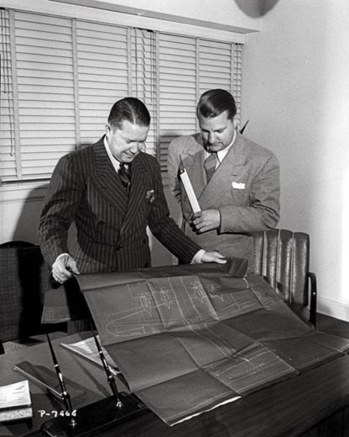  Hall Hibbard (left) and Clarence "Kelly" Leanord Johnson (1910-1990) holding a K&amp;E or Dietzgen slide rule. Both looking at a blueprint of the the Lockheed Constellation. Kelly Johnson was the engineer on 42 of the most famous planes in aviation 