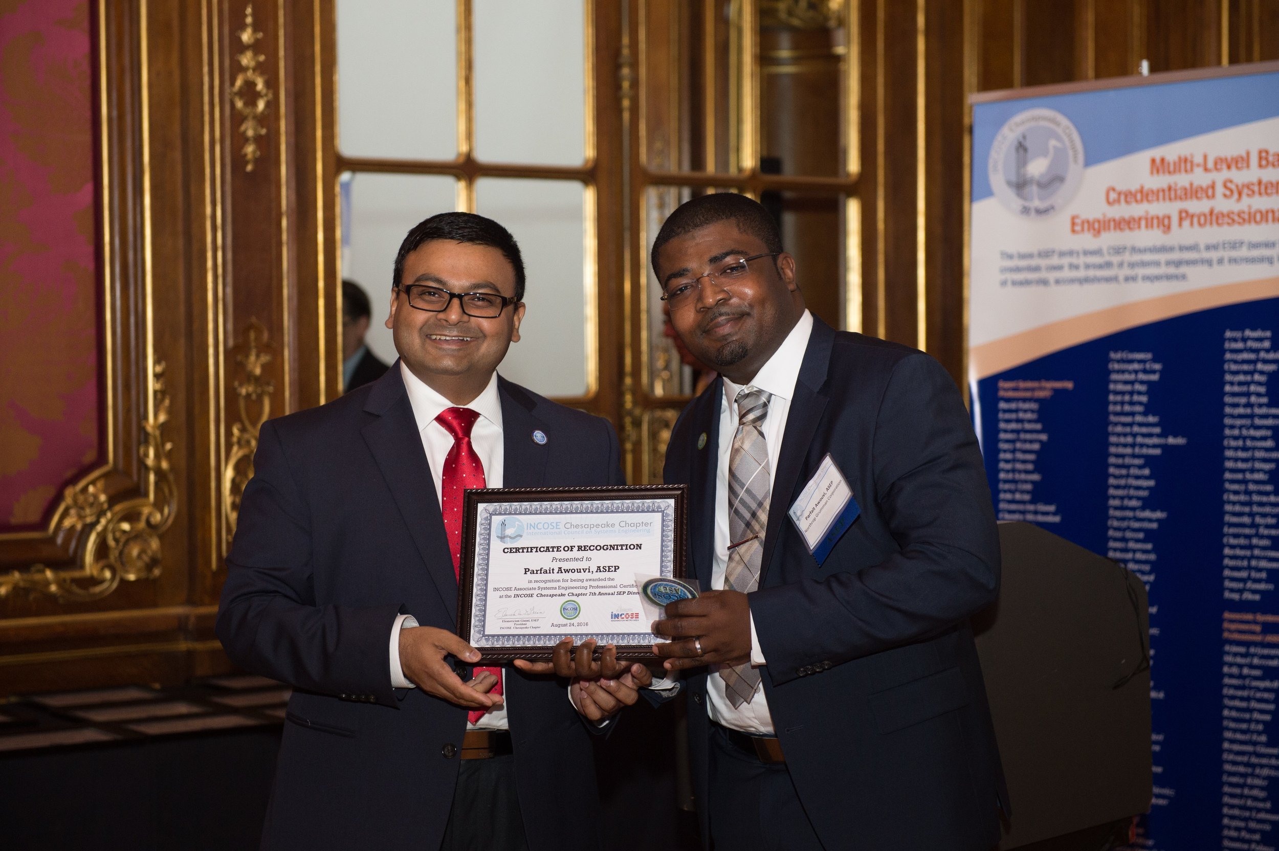 Dr. Muhamad Islam, CSEP, President of WMA, presents an ASEP Certificate of Recognition to Mr. Parfait Awouvi from Northrop Grumman Corporation.