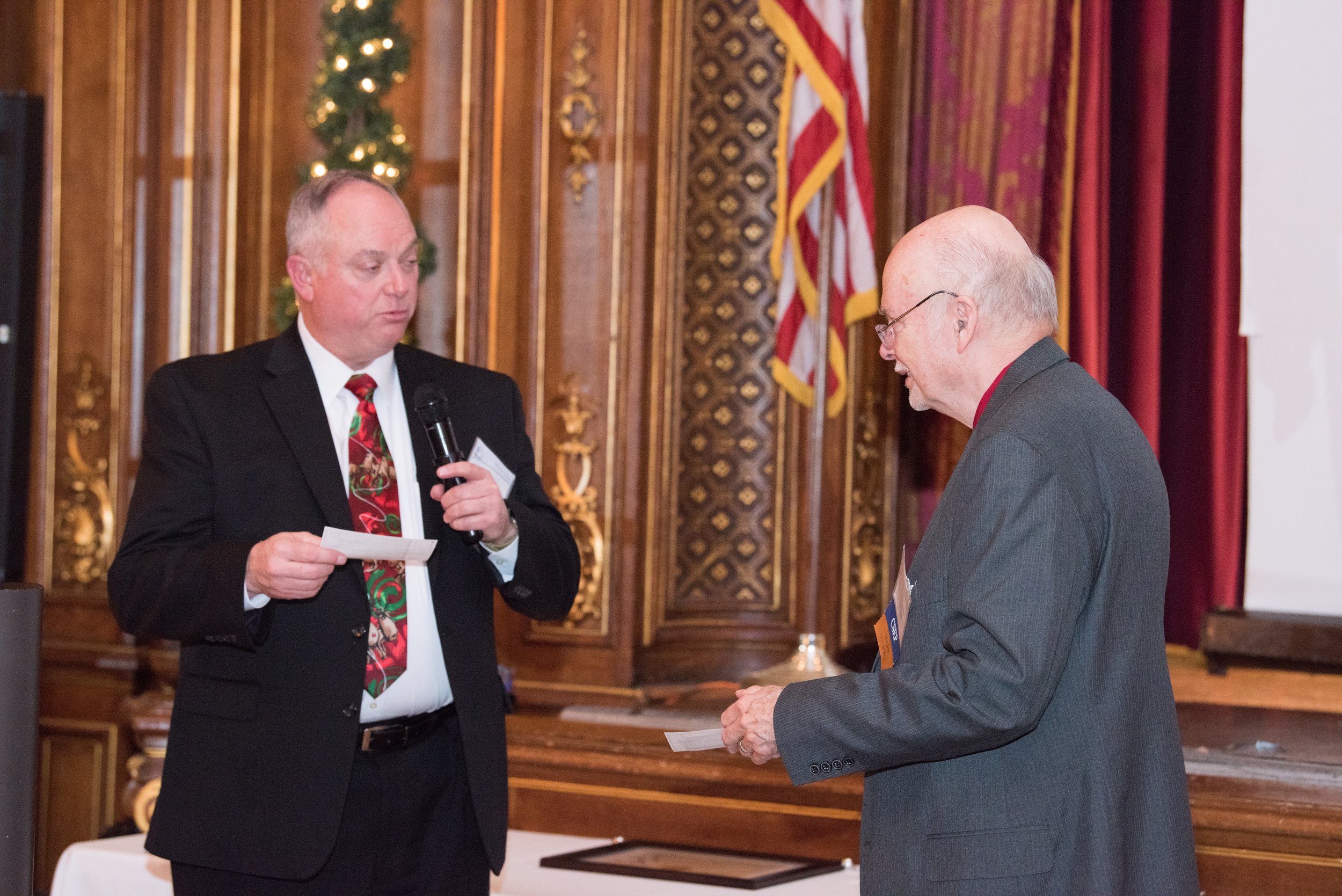 Tony Gigioli, Chapter Treasurer, presents the INCOSE Foundation donations to  Dr. John Ross Snoderly, CSEP, Foundation Chair