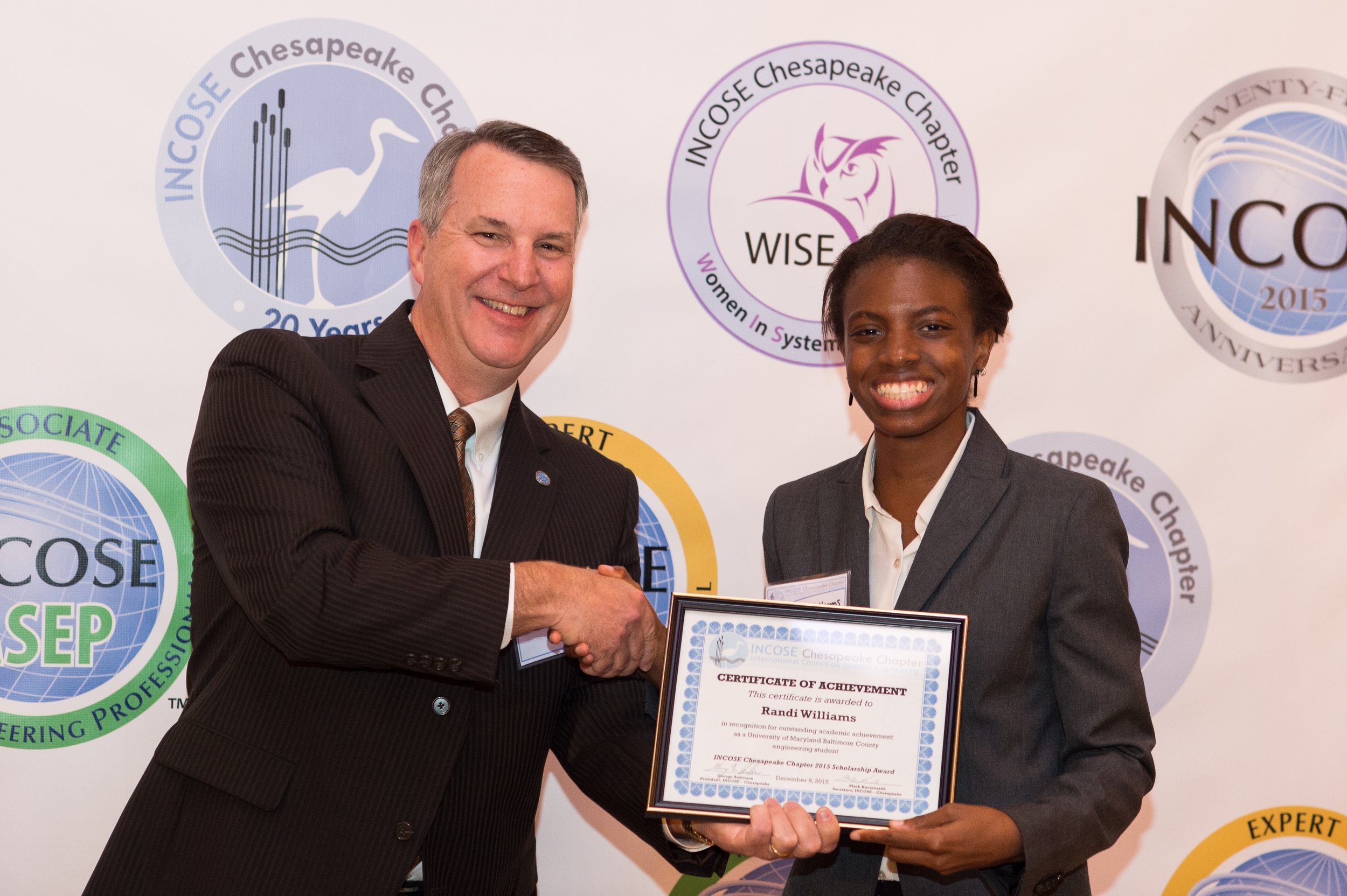 Randi Williams, University of Maryland Baltimore County (UMBC) receives a scholarship award from the Chesapeake Chapter and Chairman of the Scholarship Committee, Bob Levin.