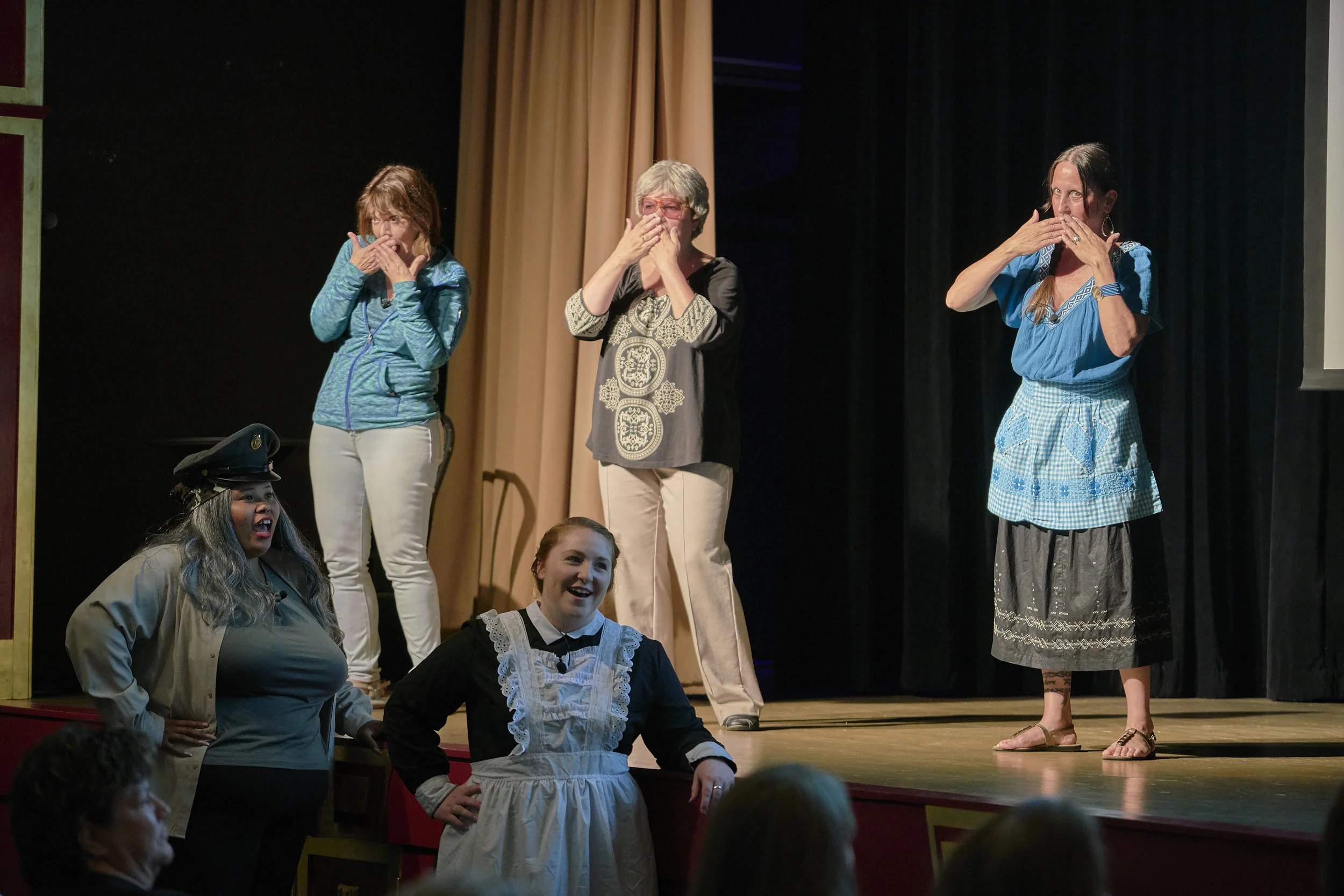 L to R on stage, Nancy Horrell as Narrator, Kathy Metzger as Lucille Hamons, and Cindy Conner as Lucia Rodriguez; and L to R below stage, Brittany Ann-Marie Taylor as Carmen, a WAC, and Brittany Roper as Margaret, a Harvey Girl, all know “when to suck it up” in the original song, “Making Good in a Man’s World,” the finale to Act One in the Pontiac production June 22-23. (Photo by Mitchell T. Fransen, courtesy of the City of Pontiac.)