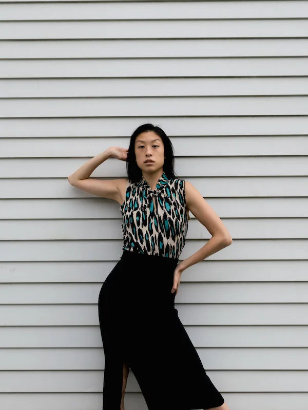 Gi Shieh sustainable style blogger wearing blue leopard keyhole knit top and black skirt