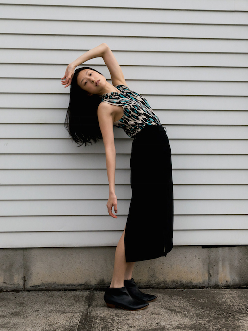 Gi Shieh wearing blue leopard print top and long black skirt