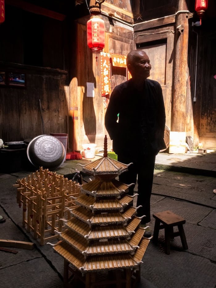 Dong architectural elder in front of building models