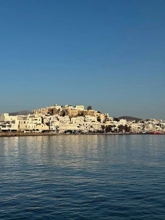  View of a Greek island town from the sea. The best eSIM for Greece provides reliable data between islands. 
