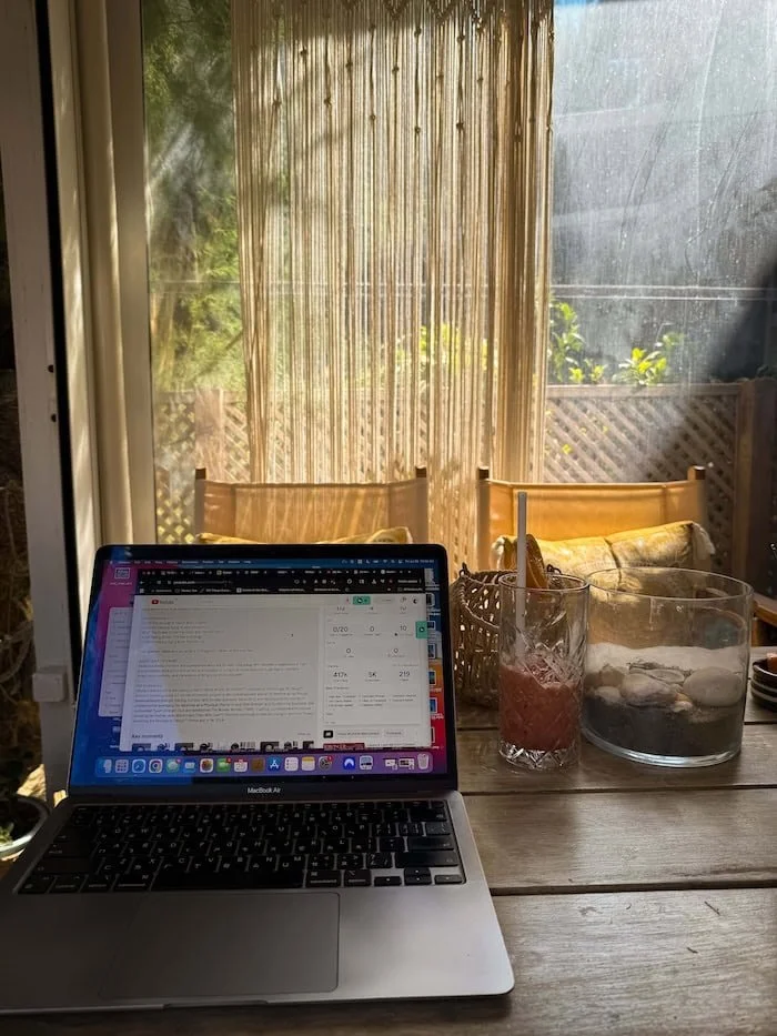  Laptop on a table in a sunny café workspace. The best eSIM for Greece makes working remotely more convenient. 