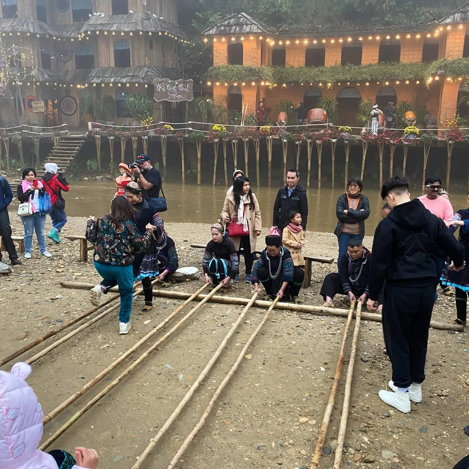 A group of locals and tourists participate in a traditional bamboo dance at Cat Cat Village in Sapa. More of a display and performance of culture than actual exchange.