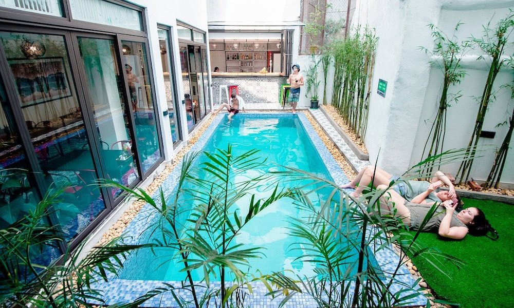 People lounging by the pool of Buffalo Hostel Hanoi Old Quarter