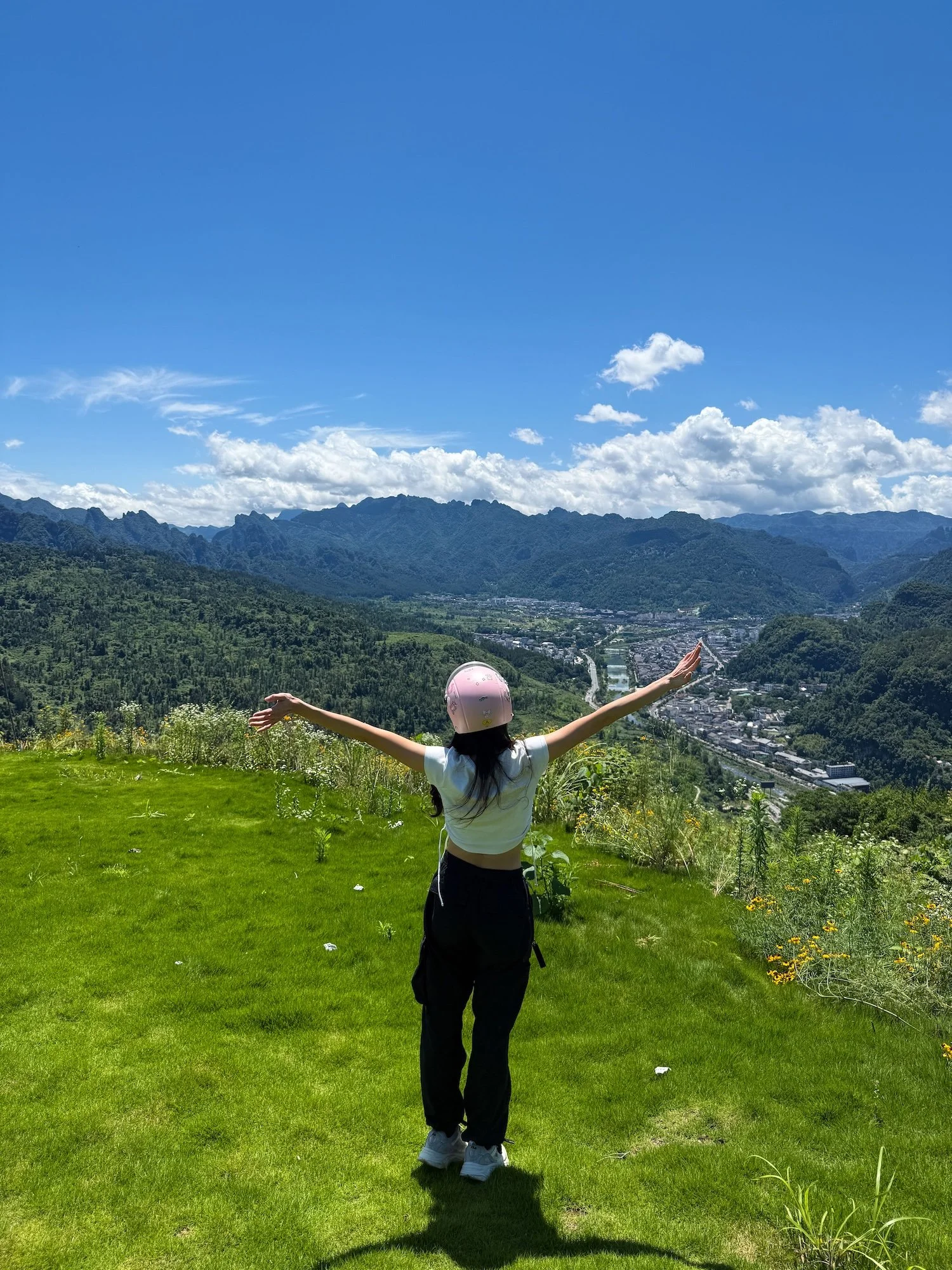 Traveler overlooking the mountains before paragliding in Zhangjiajie. This 2 week China itinerary includes unforgettable outdoor adventures.