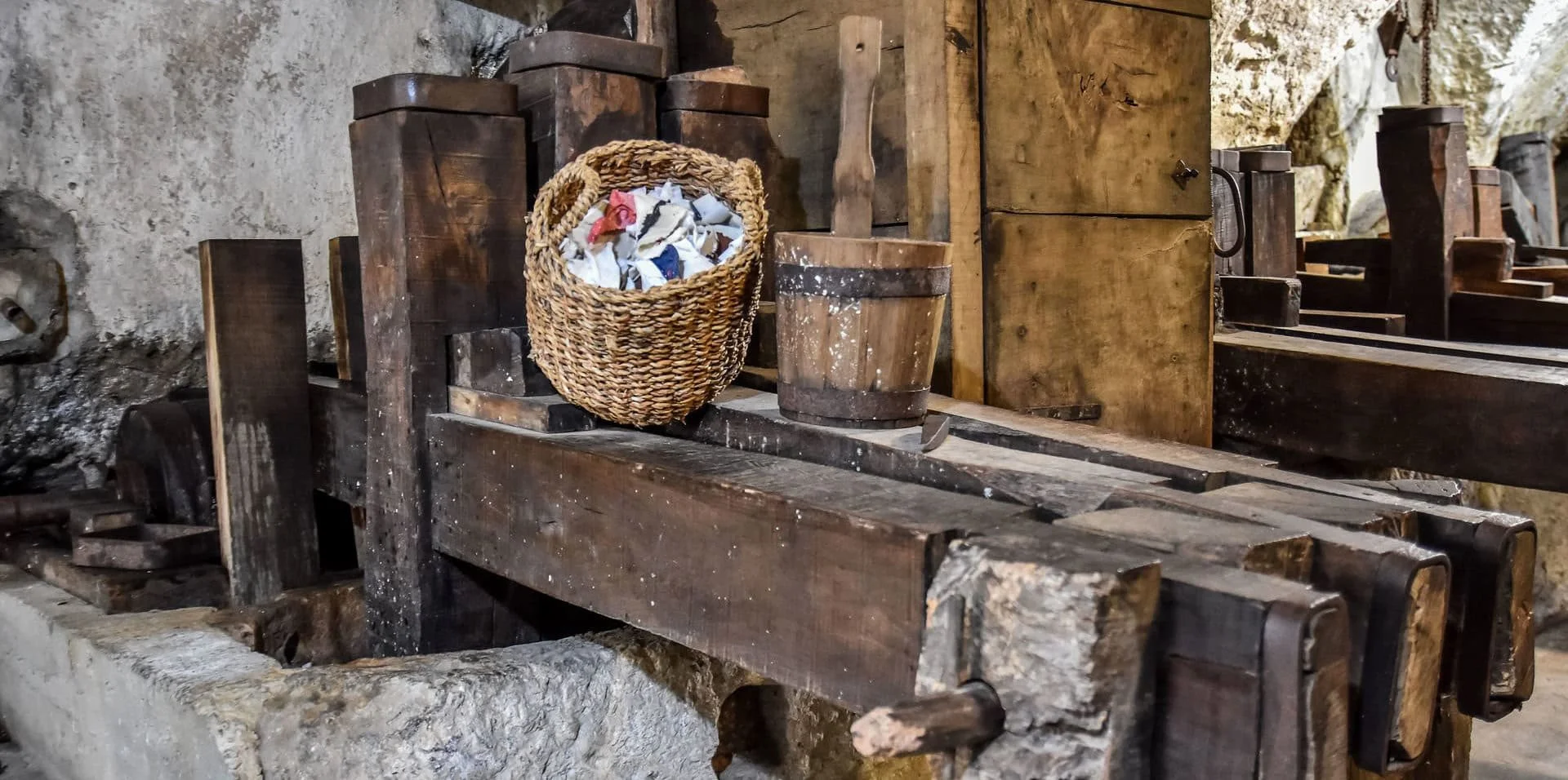 Antique wooden paper making equipment and tools displayed inside the historic Amalfi paper mill museum. Learning about traditional paper production is one of the cultural Amalfi Coast things to do.