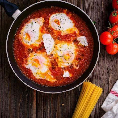 Image of shakshuka homemade meal sitting on wooden table
