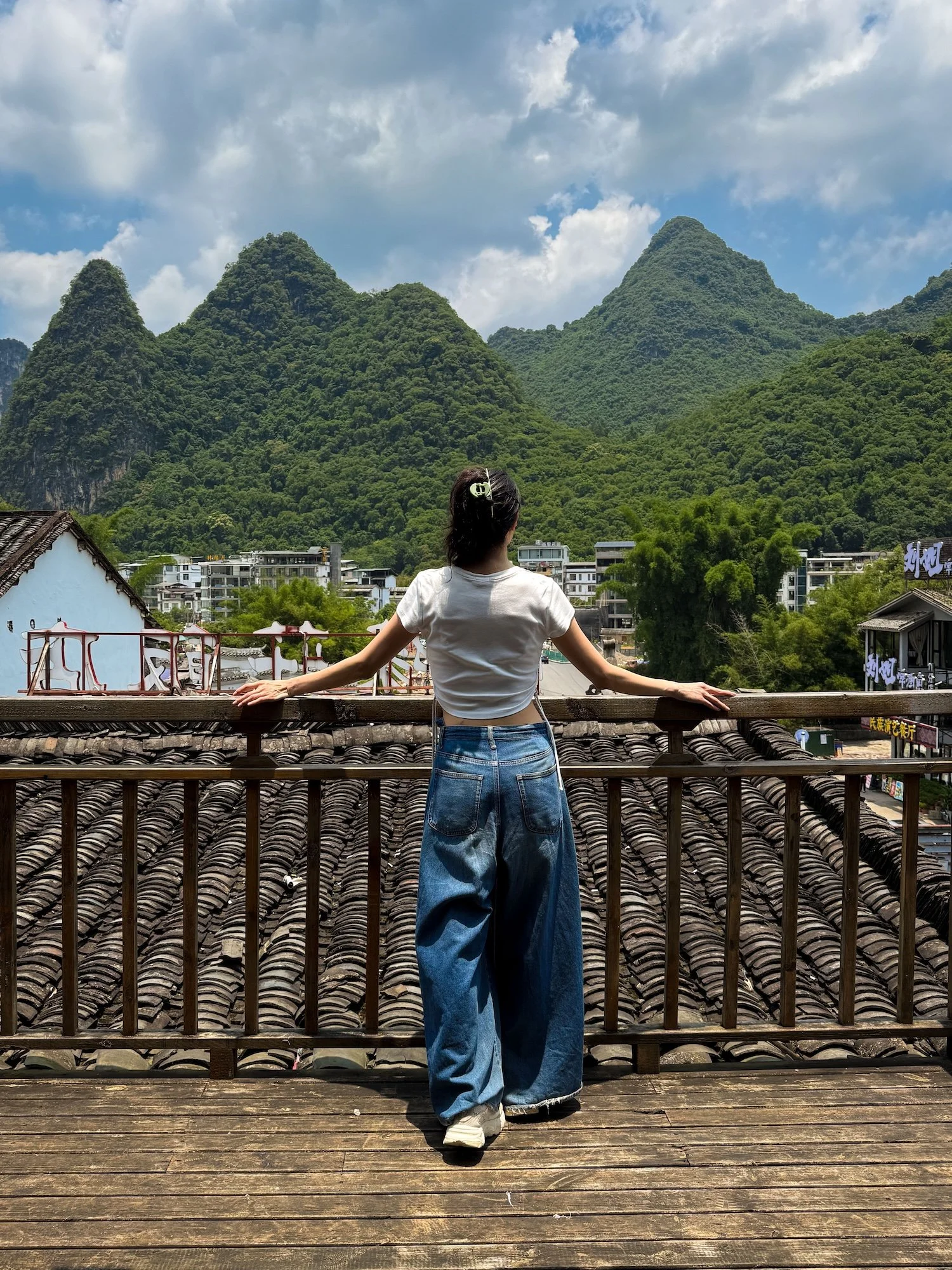Traveler overlooking the karst mountains in Yangdi Xingping Ancient Town. This 2 week China itinerary includes the stunning landscapes of Guilin.