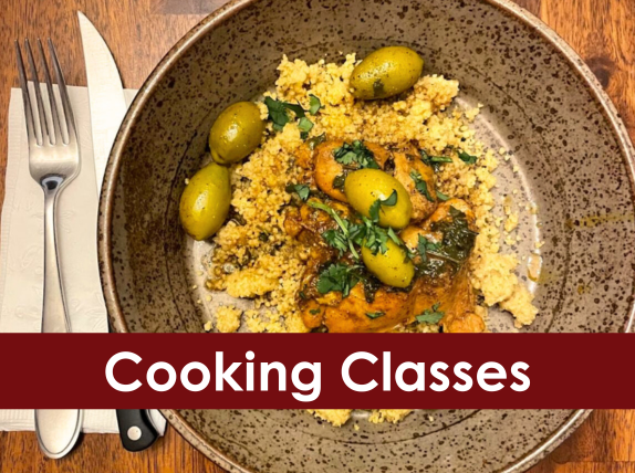 A plate with coucous, chicken and green olives