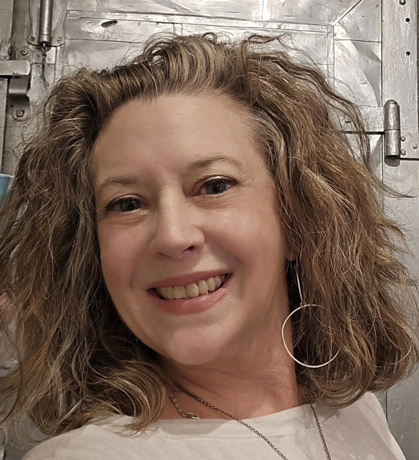 Photo of Dominique Winder who is smiling and has wavy hair