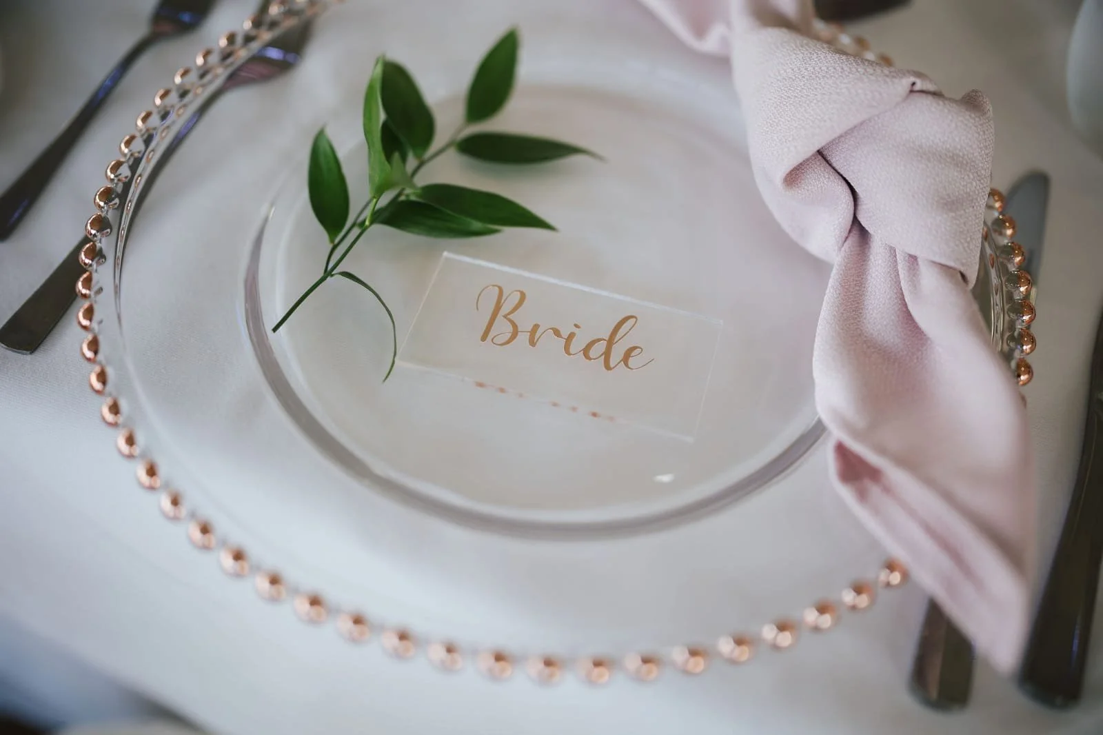 Rose Gold Beaded Charger Plate with Acrylic Name Place Setting, coloured napkin and foliage detailing